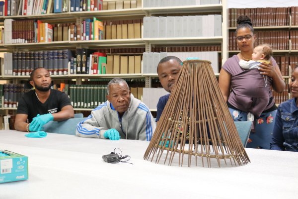 Members of the 2019 VEKE delegation examine fishing paraphernalia presented during the Vezo ecological exchange at the Smithsonian Museum Support Center. This photo shows a ‘kimana’ which is used for trapping fish and shrimp near shore or in mangrove areas.